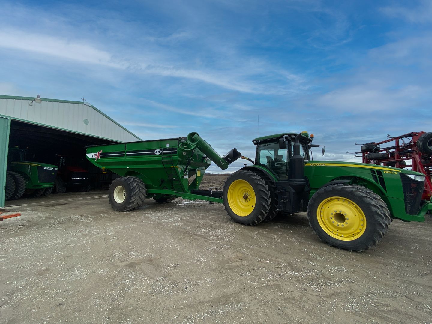 J&M Grain Carts come in Green, Black, Red, and Blue. The auger is in the field ready position. 